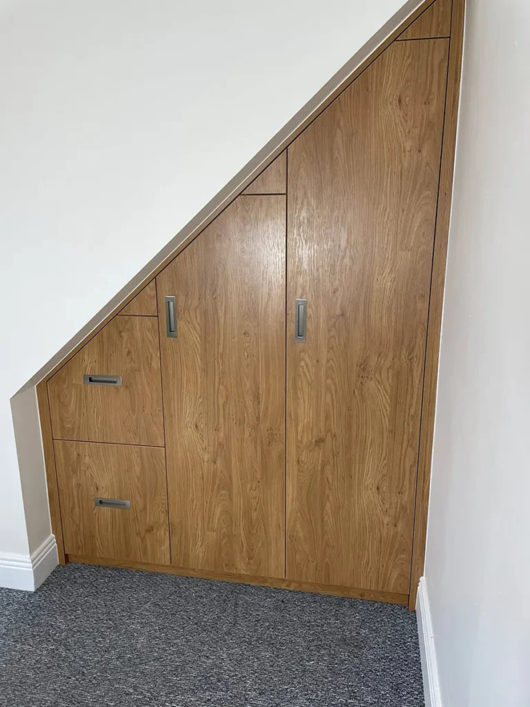 Small fitted wardrobe under the stairs