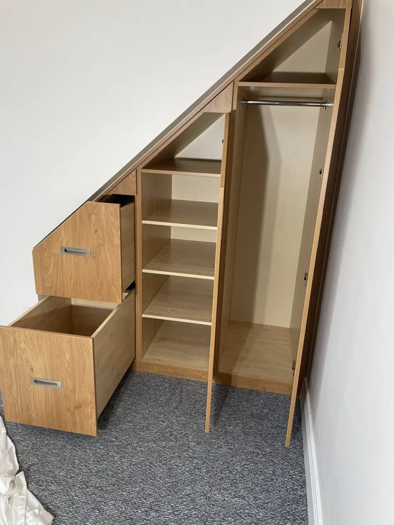 Small fitted wardrobe under the stairs